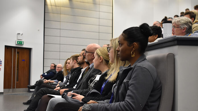 A view of people sitting in the front of a lecture theatre