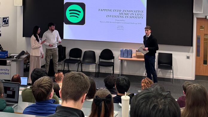 A man stands in front of a presentation screen to make a pitch during the Investment Challenge with RBC Brewin Dolphin Investment and Wealth Management