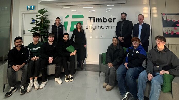A group photo of students visiting the offices of Timber Engineering