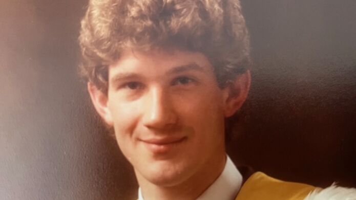 1985 portrait of Andrew Walker in graduation gown