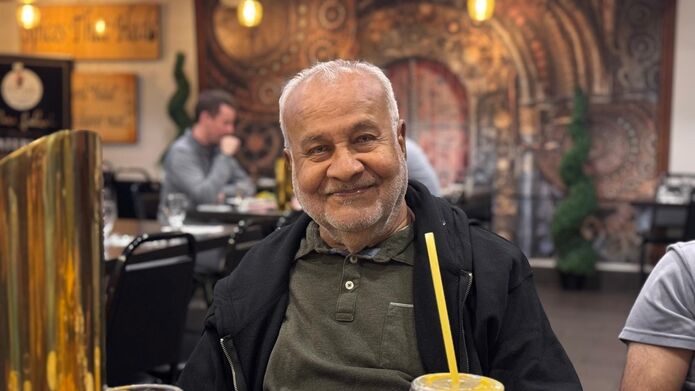 man sitting at dinner table in restaurant