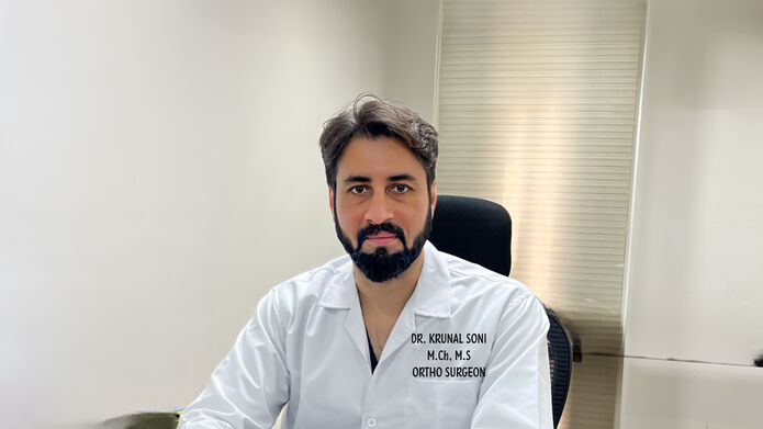 man sitting in medical lab coat