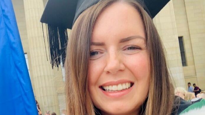 portrait of Samantha Brown wearing a graduation gown