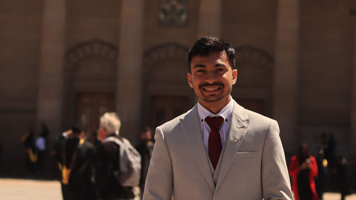 Person wearing suit standing in front of Caird Hall