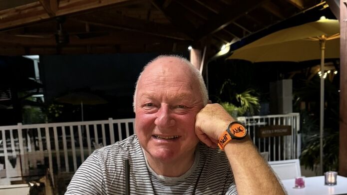 Man sitting at table holding a cocktail