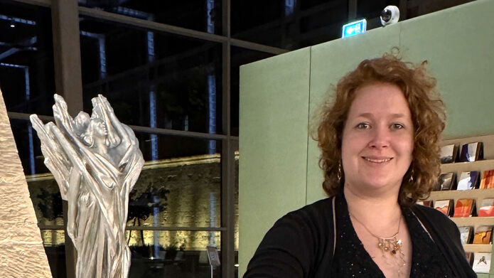 Woman standing next to display of jewellery