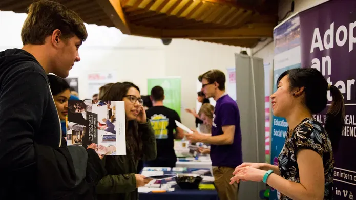Students meeting employers at careers fair