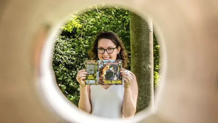 Hailey Austin holding up her comic book