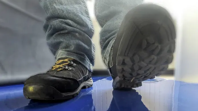 A pair of shoes walking towards a camera