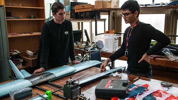 students working on a drone