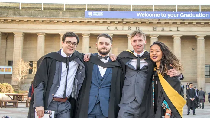 students in gowns at graduation