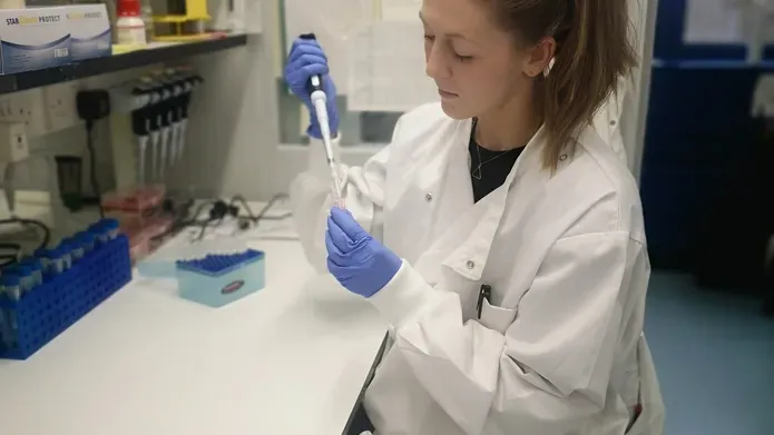 Dr Amy Lloyd sitting in her lab
