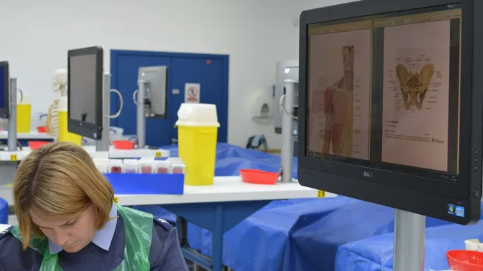 A photograph of a person in uniform working in the Thiel Cadaver Facility