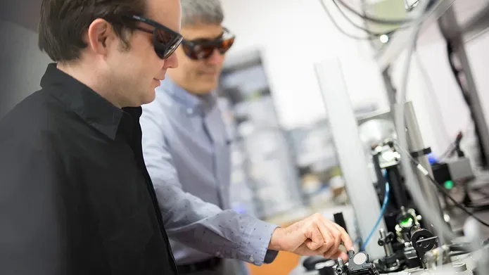two men using the Applied Laser Technology Laboratory 
