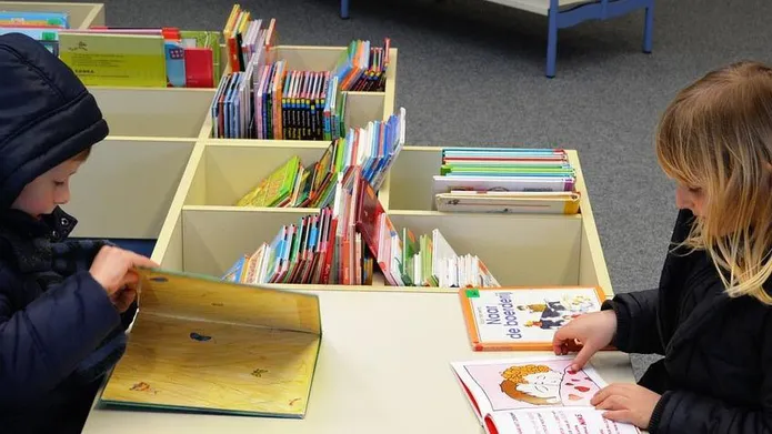Boy and girl reading books