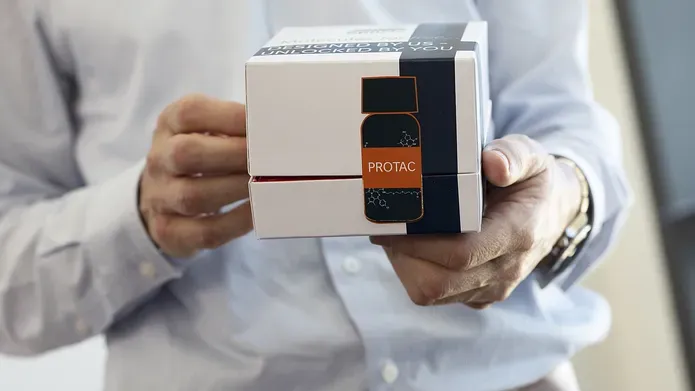 a man from the neck down holding a box