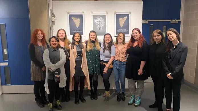a group of people smiling at an exhibition