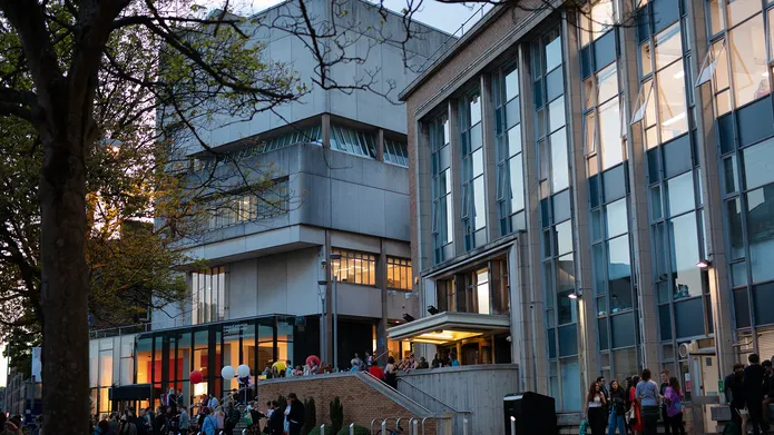 people standing outside the art school