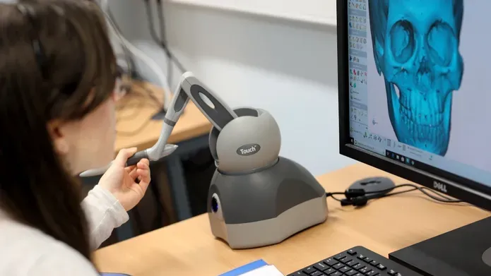 a student using a computer with facial imaging software