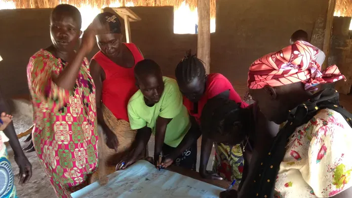 people in Africa standing around a table