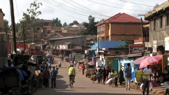 a busy street with people shopping and people on bikes