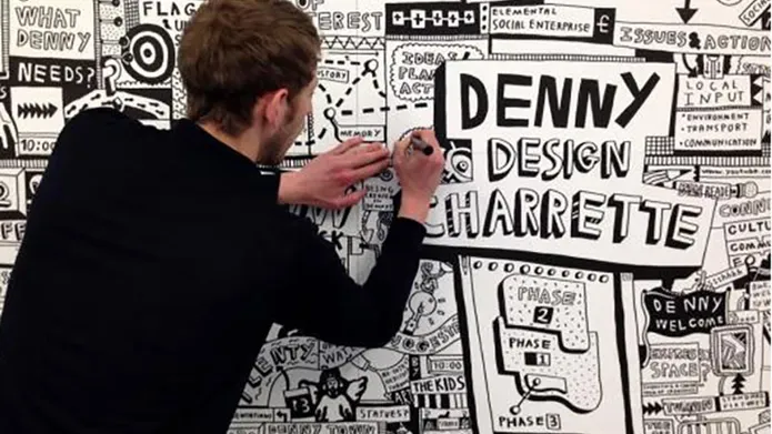 Man drawing in black and white on a wall