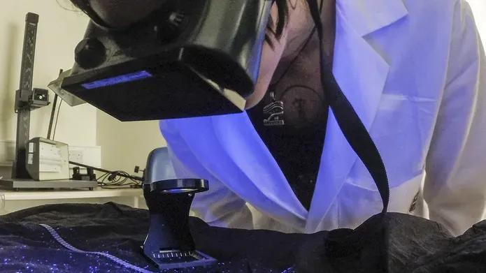 a person looking at materials using UV light