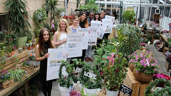Students standing in a conservatory with lots of plants