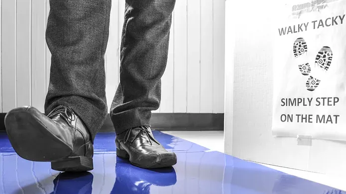 feet walking on a blue sticky mat