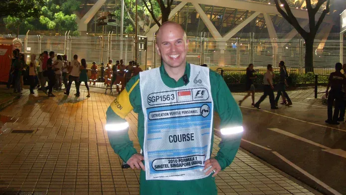 a man with a city lit up behind him