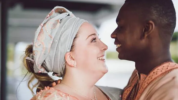 a woman and a man looking into each other's eyes