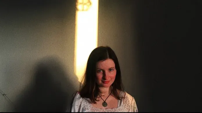 an image of a woman with a dark background behind her