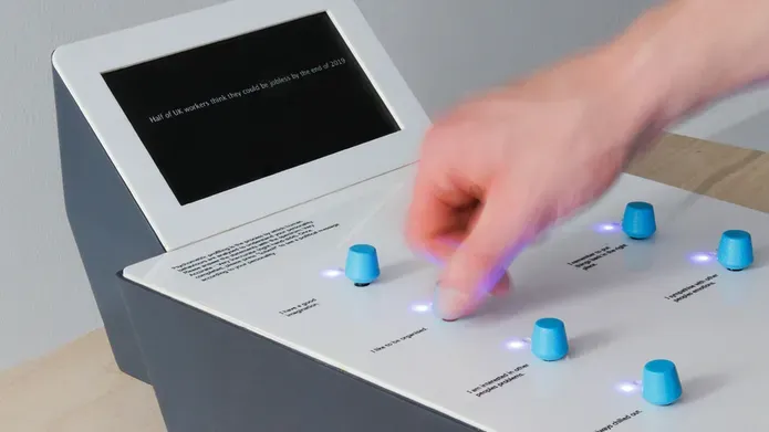 a hand pressing blue buttons on a machine