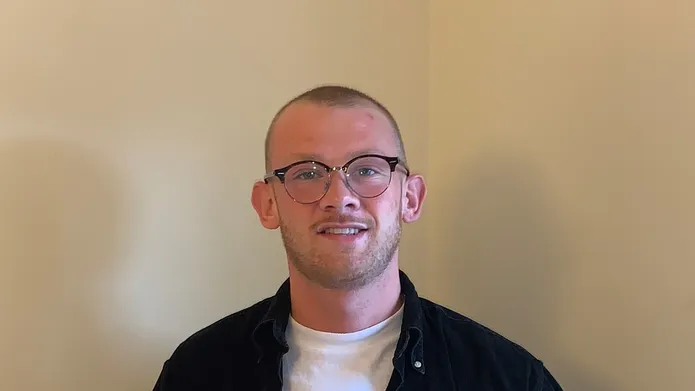an image of Angus holding an American Express mug