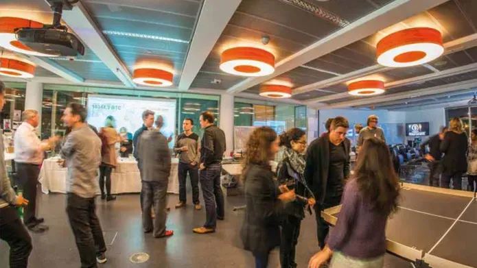 students in an exhibition hall with decorative lights on the ceiling