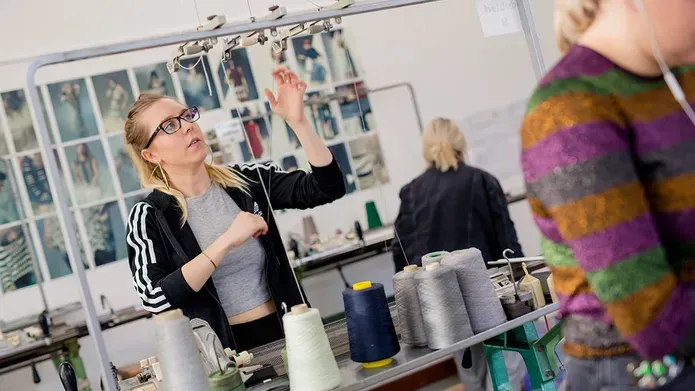 Student using a knitting machine in DJCAD