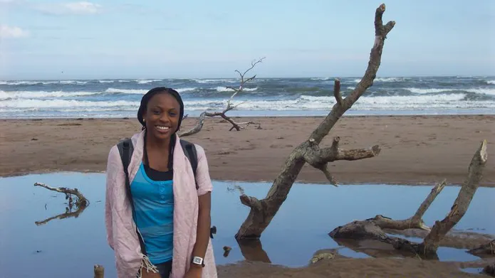 Monica standing on a beach