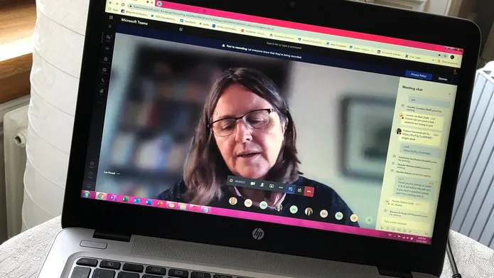 An image of a member of staff on a laptop