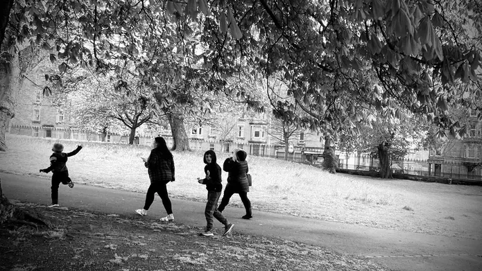 a black and white image of a small group of people walking