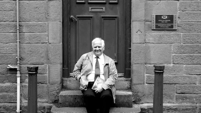 Eddie Small sat on the steps of Mary Lily Walker's house