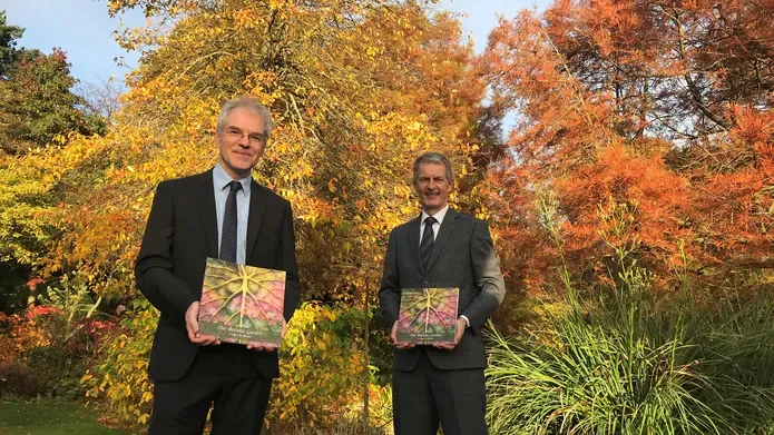 Dr Mark McGilchrist, Chair, Friends of the University Botanic Garden, and Principal Professor David Maguire holding the anthology