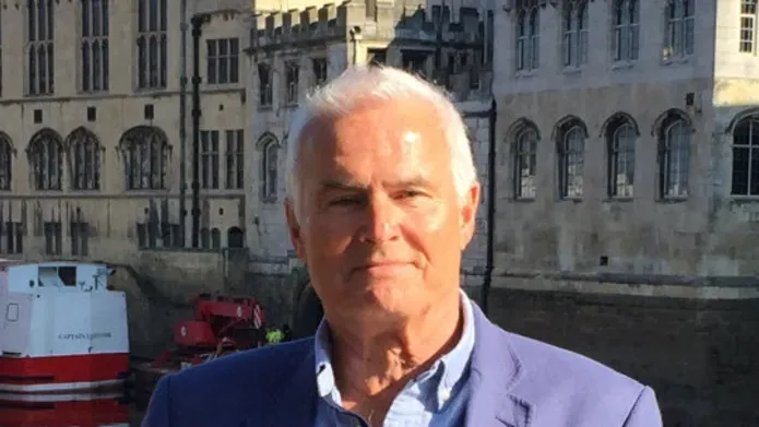 Graeme Martin standing with buildings behind him