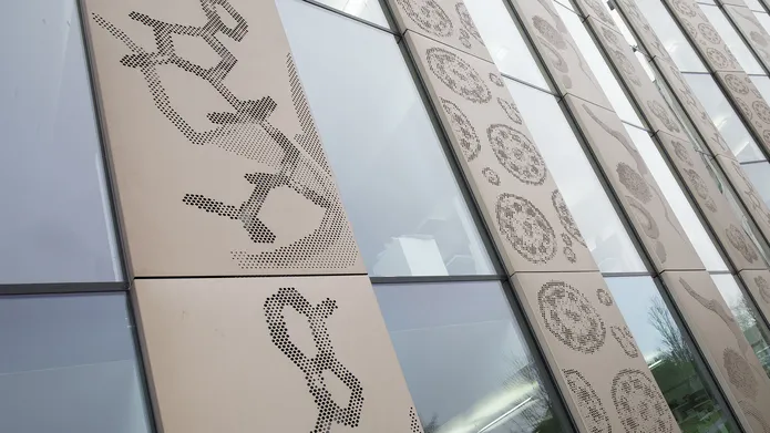 photograph of the side of the Discovery Building featuring the Scales of Life art collaboration