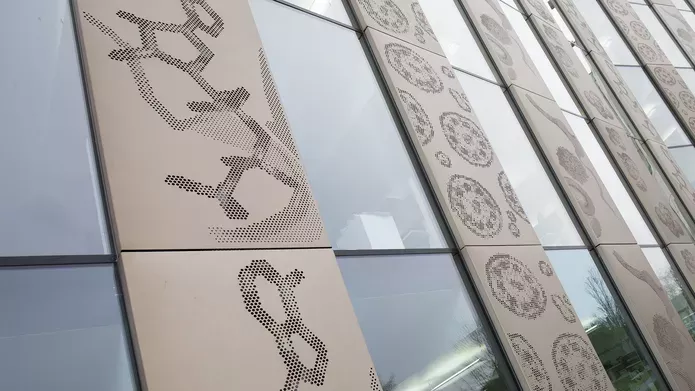 photograph of the side of the Discovery Building featuring the Scales of Life art collaboration