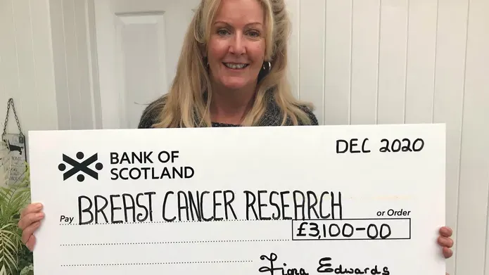 Fiona Edwards with cheque for breast cancer research