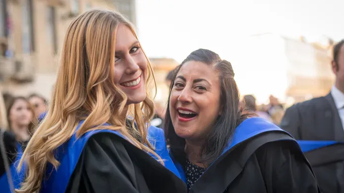 two girls with blue hoods after graduating