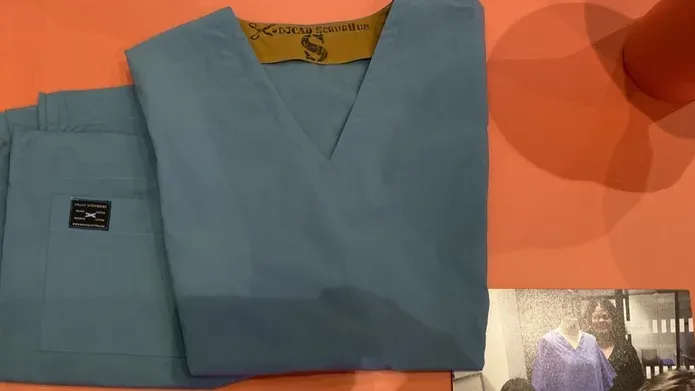 tayside teal scrubs set folded on table