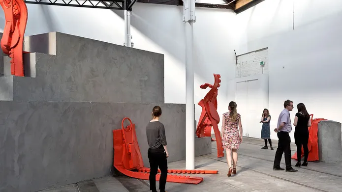 People in exhibition with large red zips