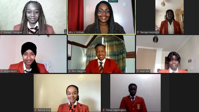 Brookhouse school pupils in red uniform smiling on video call