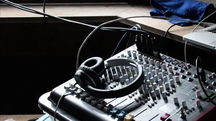 an image of headphones and a sound desk